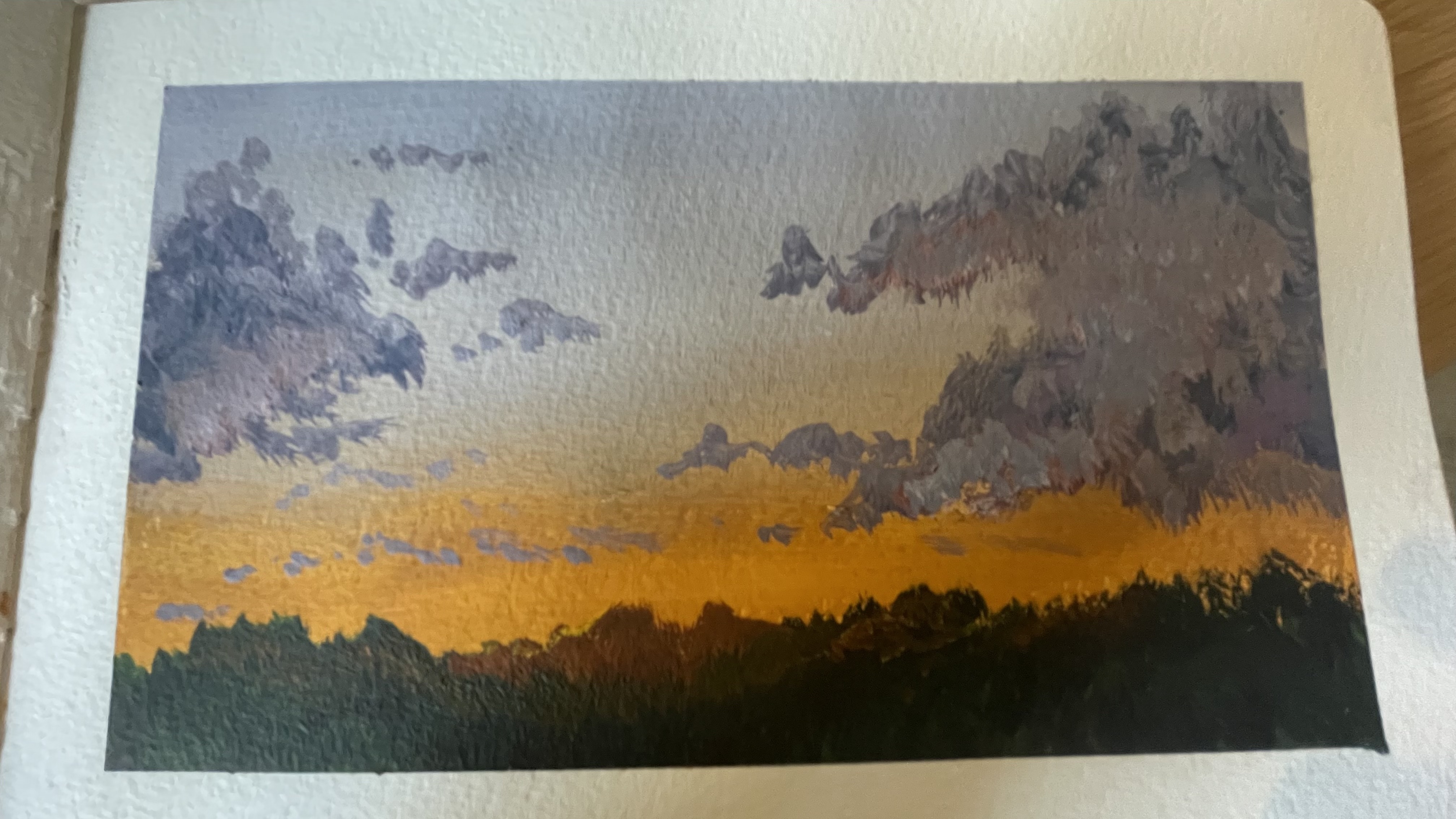 An oil painting of a dramatic sunset sky, purple-grey clouds glowing orange along the horizon above a dark treeline silhouette