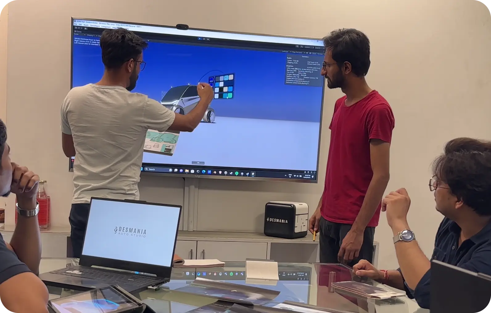 The Desmania team reviewing a concept car design on-screen